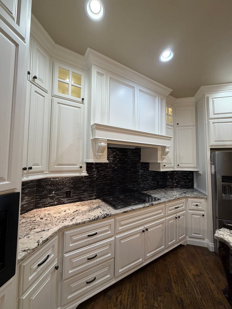 Modern kitchen with white cabinetry, black subway tile backsplash, granite countertops, and recessed lighting